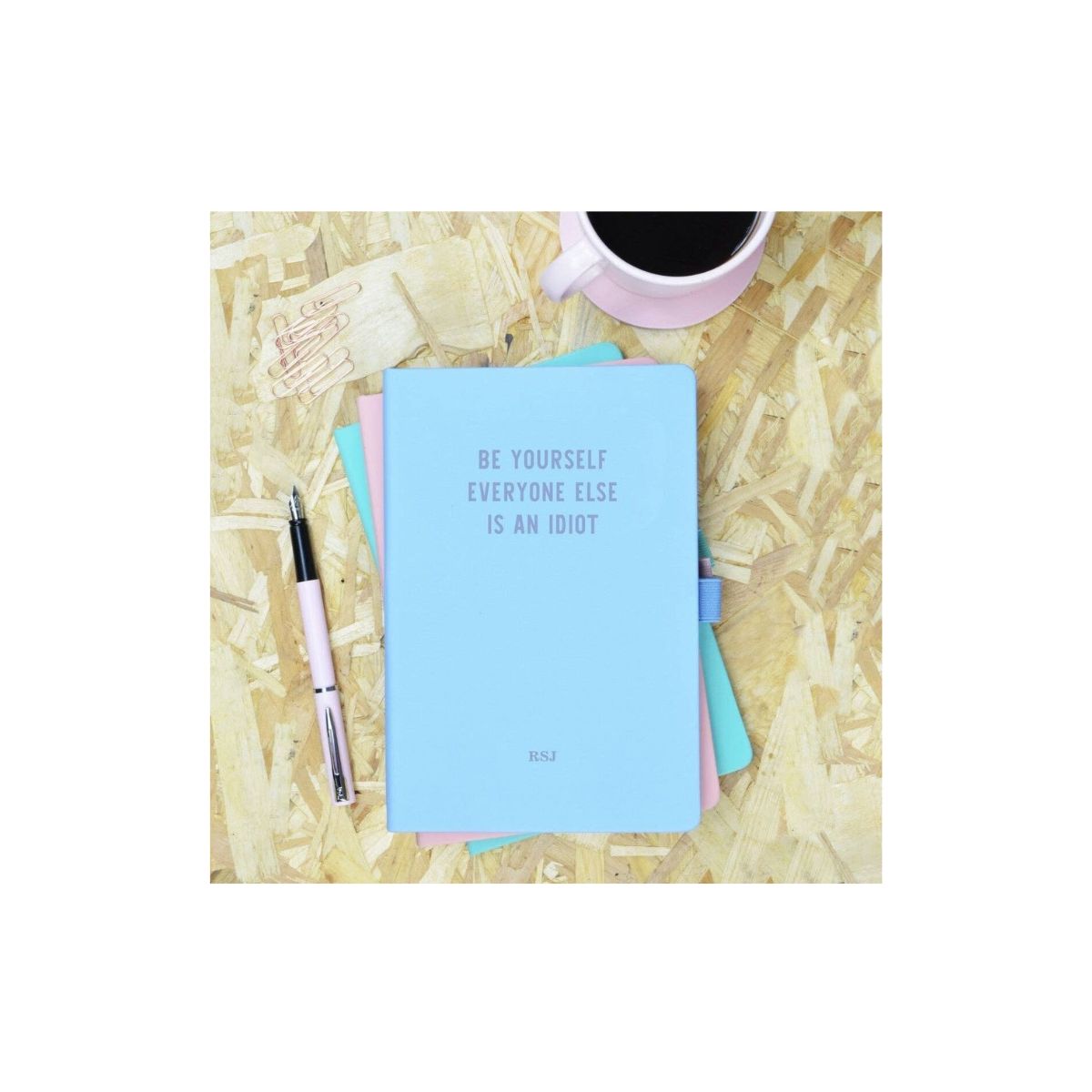  Be Yourself Everyone Else is an Idiot Blue & Purple Personalised Notebook Cute blue hardback PU notebook with purple 'Be Yourself Everyone Else is an Idiot' slogan. Baby blue PU notebook with 96 blue edged pages, elastic fastening and pen holder.